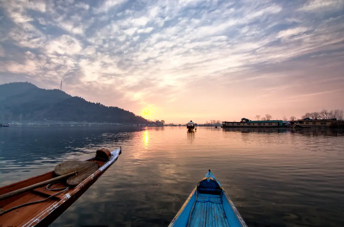 Dal Lake at sunset with shikaras resting on calm water